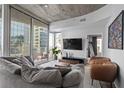 Spacious living area with plush seating, balcony access, and city view at 155 S Court Ave # 1202, Orlando, FL 32801