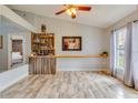 Bright living room with a bar area, built-in shelves, and ample natural light from a large window at 157 Long Pine Dr, Deltona, FL 32725