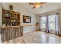 Comfortable living area featuring a custom bar with shelving, perfect for entertaining guests at 157 Long Pine Dr, Deltona, FL 32725