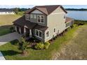 Stunning two-story home featuring manicured landscaping and a serene lake view at 200 Valencia Ridge Dr, Auburndale, FL 33823