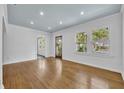 Bright living room featuring gleaming hardwood floors, fresh white walls, and ample natural light at 2004 E Marks St, Orlando, FL 32803