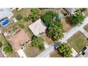 This aerial view showcases a lovely home nestled among mature trees in a quiet neighborhood at 2025 Claremont Dr, Deltona, FL 32725
