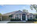 Beautiful single-story home with an attached two-car garage and a neatly landscaped front yard at 2025 Claremont Dr, Deltona, FL 32725