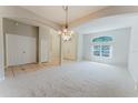 Spacious living room featuring neutral colors, large arched doorways, and a chandelier at 2025 Claremont Dr, Deltona, FL 32725