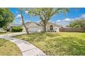 Beautiful single-story residence displaying a spacious front yard and mature trees at 2381 Pinebrook Ct, Oviedo, FL 32766