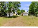 Large backyard with green grass and multiple buildings with lattice at 2519 Gabriel Rd, Fort Meade, FL 33841