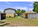 Spacious backyard featuring the main house and a separate building, connected by a stone pathway at 2519 Gabriel Rd, Fort Meade, FL 33841
