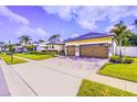 Lovely home with well-kept landscaping, a paved driveway, and lush green lawn at 2626 Greenwillow Dr, Orlando, FL 32825