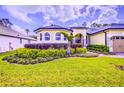 Charming home with meticulous landscaping and a well-manicured, green lawn at 2626 Greenwillow Dr, Orlando, FL 32825