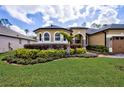 Lush landscaping compliments the front yard and facade of this beautiful single Gathering home at 2626 Greenwillow Dr, Orlando, FL 32825