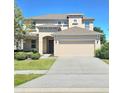 Spacious two-story home featuring a two-car garage and a well-manicured front yard at 3301 Bethpage Loop, Mount Dora, FL 32757