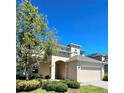 Charming home featuring manicured bushes, neutral stucco, and a well-kept lawn at 3301 Bethpage Loop, Mount Dora, FL 32757