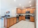 Open kitchen with stainless steel appliances, granite countertops, and ample cabinet space at 332 Blue Lake Cir, Kissimmee, FL 34758