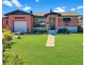 Charming single-story brick home with a manicured lawn and inviting walkway under a sunny sky at 340 Zelda Blvd, Daytona Beach, FL 32118