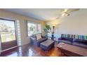 Comfortable living room featuring hardwood floors, a leather sofa and chair, and a bright window at 340 Zelda Blvd, Daytona Beach, FL 32118