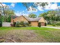 Spacious home with lush landscaping, long driveway and a well-manicured lawn at 400 Shelby Ct, Apopka, FL 32712