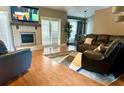 Inviting living room with a fireplace, wood floors, and a comfortable seating arrangement at 400 Shelby Ct, Apopka, FL 32712