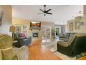 Comfortable living room with fireplace, plush seating, and access to outdoor living at 400 Shelby Ct, Apopka, FL 32712