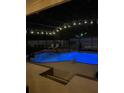 Backyard pool and spa illuminated at night, perfect for relaxation and outdoor enjoyment at 400 Shelby Ct, Apopka, FL 32712