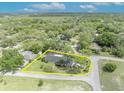 Expansive aerial view showcases a single-story home with mature trees, and well-maintained landscaping at 401 Sanford Ave, Longwood, FL 32750