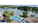 Community pool featuring lounge chairs with beautiful lake views surrounded by mature trees at 408 E Orlando Ave # 2A, Ocoee, FL 34761
