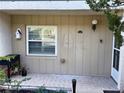 Charming condo entrance with a birdhouse, tiled porch, and space for potted plants at 408 E Orlando Ave # 2A, Ocoee, FL 34761