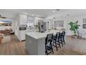 Modern kitchen featuring a large center island, white cabinets, and stainless steel appliances at 4636 Mesa Verde Dr, St Cloud, FL 34769