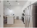 A modern kitchen featuring stainless steel appliances and a stylish island at 485 Famagusta Dr, Davenport, FL 33896
