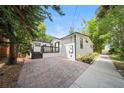 Charming home featuring a brick-paved courtyard, dark trim, a deck, and landscaping at 506 S Hyer Ave, Orlando, FL 32801