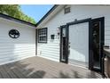 Inviting front entrance with a clean, white door and decorative black trim and a cozy deck at 506 S Hyer Ave, Orlando, FL 32801