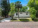 Bungalow exterior with brick paved street, landscaped yard, and mature trees at 506 S Hyer Ave, Orlando, FL 32801