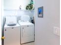 Laundry room featuring a white washer and dryer, and shelving at 509 New Providence, Davenport, FL 33897