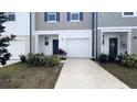 Charming townhome with a one-car garage, well-manicured landscaping, and a private driveway at 516 Madison Dr, Davenport, FL 33837