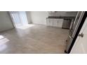 Bright and airy kitchenette area with ample space, stainless steel appliances, and tiled flooring at 516 Madison Dr, Davenport, FL 33837