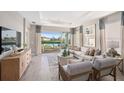 Stylish living room with modern decor, lake view, and comfortable seating at 5333 Spoonflower Ct, St Cloud, FL 34771