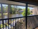 Relaxing balcony view overlooking a tranquil pond surrounded by lush greenery at 5926 Peregrine Ave # A13, Orlando, FL 32819