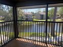 Serene balcony view overlooking a peaceful pond surrounded by well-maintained lawns and trees at 5926 Peregrine Ave # A13, Orlando, FL 32819