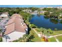 Aerial view of the community with a large lake, mature landscaping, pool and walking paths at 6 Escondido Cir # 64, Altamonte Springs, FL 32701