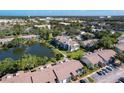 Community aerial view featuring a scenic lake, mature trees, pool area, and well-maintained landscaping at 6 Escondido Cir # 64, Altamonte Springs, FL 32701