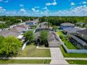 Charming single-Gathering home with a well-manicured lawn, mature trees, and a two-car garage at 610 Carey Way, Orlando, FL 32825