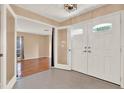 Bright foyer featuring double doors, carpet, and neutral walls, creating a welcoming entry at 650 Sweetbriar Br, Longwood, FL 32750