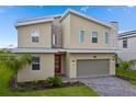 Stylish two-story home showcasing contemporary design, a stone accent wall, and a neatly paved driveway at 905 Ocean Course Ave, Davenport, FL 33896