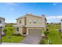 Beautiful modern home with a two-car garage, stone accents, manicured lawn, and vibrant landscaping at 905 Ocean Course Ave, Davenport, FL 33896