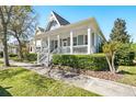 Charming single Gathering home with inviting porch and well-manicured landscaping on a sunny day at 931 Croton Rd, Celebration, FL 34747