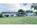 Cozy home with landscaped front yard and covered carport at 1118 Arrowsmith Ave, Orlando, FL 32809