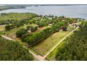 Large estate with well-defined property lines, mature trees, and a sprawling green lawn at 11200 Lane Park Rd, Tavares, FL 32778