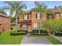 Attractive two-story townhome with brick-paved driveway and manicured front yard at 130 Palermo St, Davenport, FL 33897