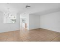 Open living room with tile flooring and plenty of natural light at 131 Heritage Park St, Winter Springs, FL 32708