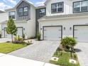 This townhome has a two-car garage, coordinated landscaping, and paver driveway at 1438 Brookdale Ct, Oviedo, FL 32765