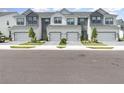 The exterior displays several townhomes with two car garages, green lawns, and paver driveways at 1438 Brookdale Ct, Oviedo, FL 32765